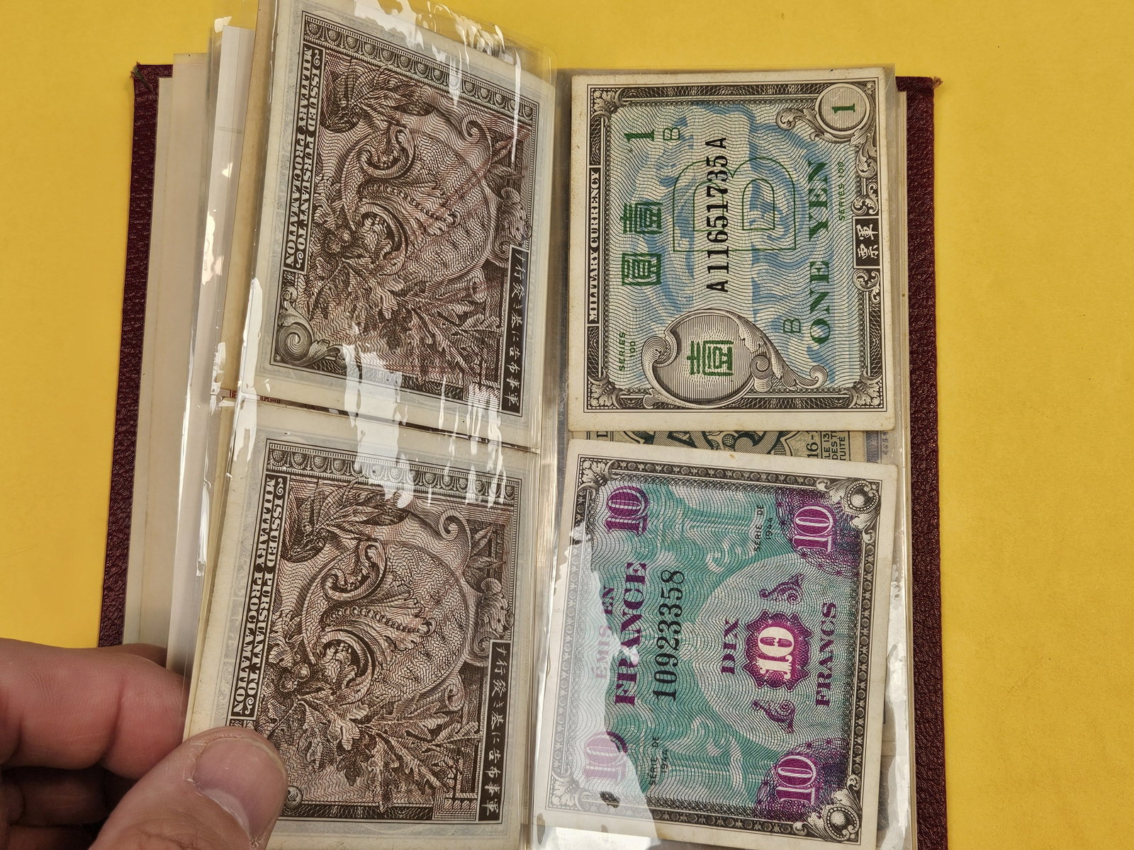 Hardcover booklet with about 40 or so pieces of World Currency - 5