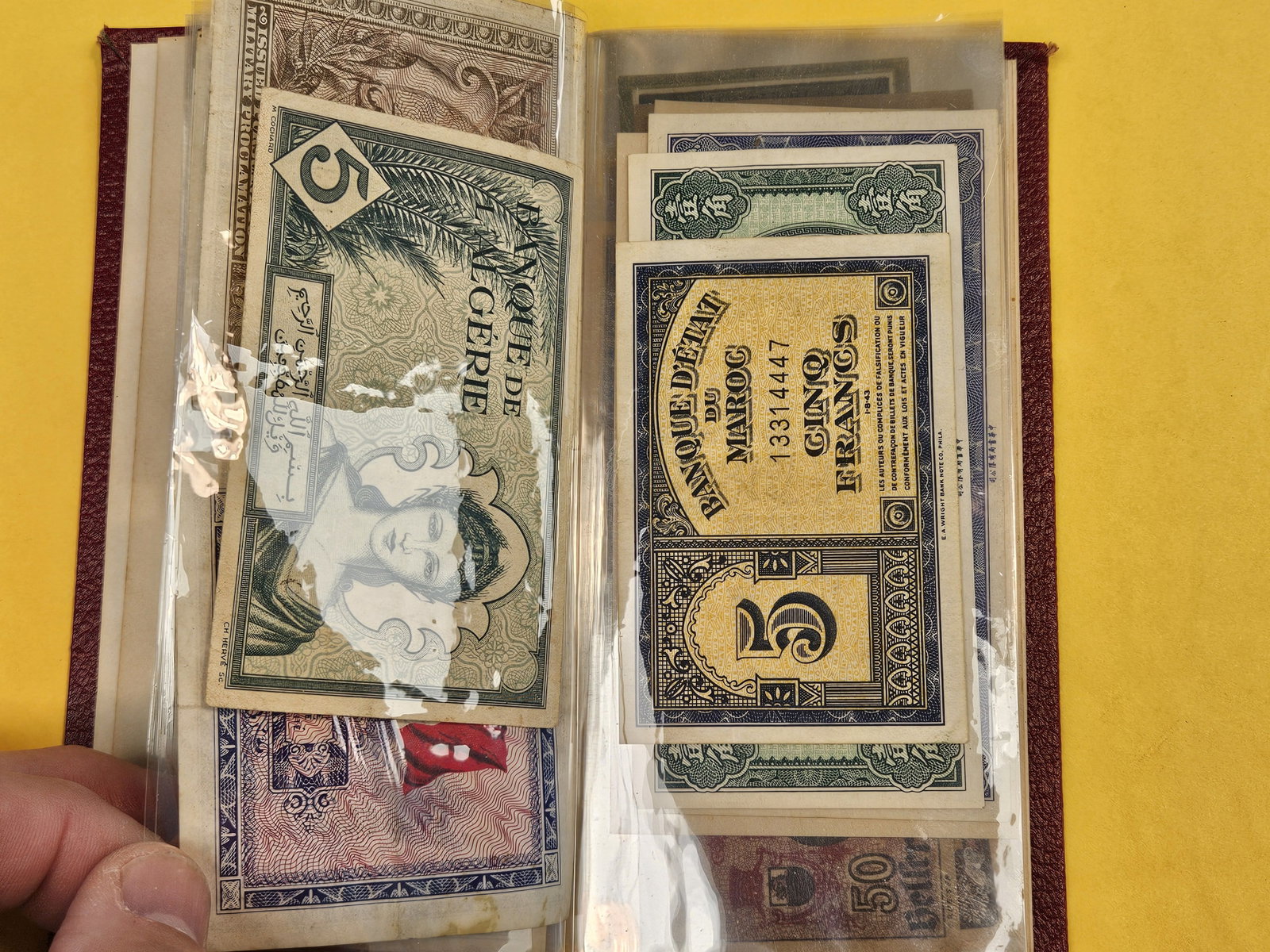 Hardcover booklet with about 40 or so pieces of World Currency - 6