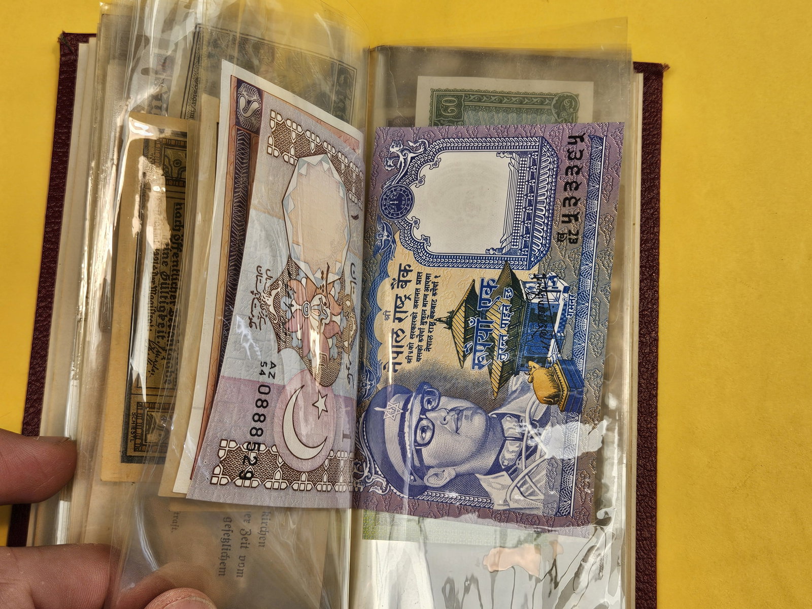 Hardcover booklet with about 40 or so pieces of World Currency - 9