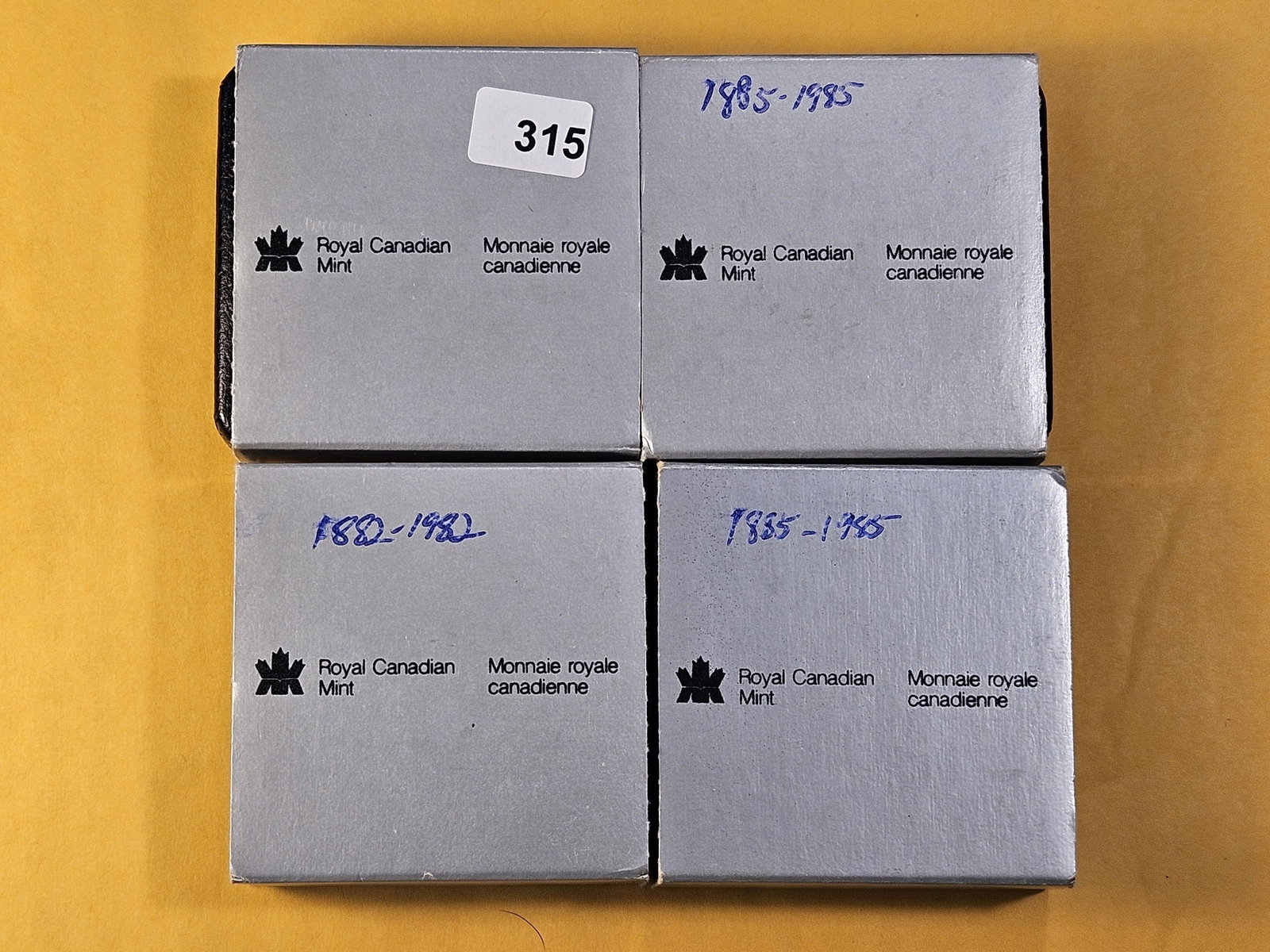 Four Royal Canadian Mint Silver Dollars: 1982, and three 1985. In OGP, three have COA's