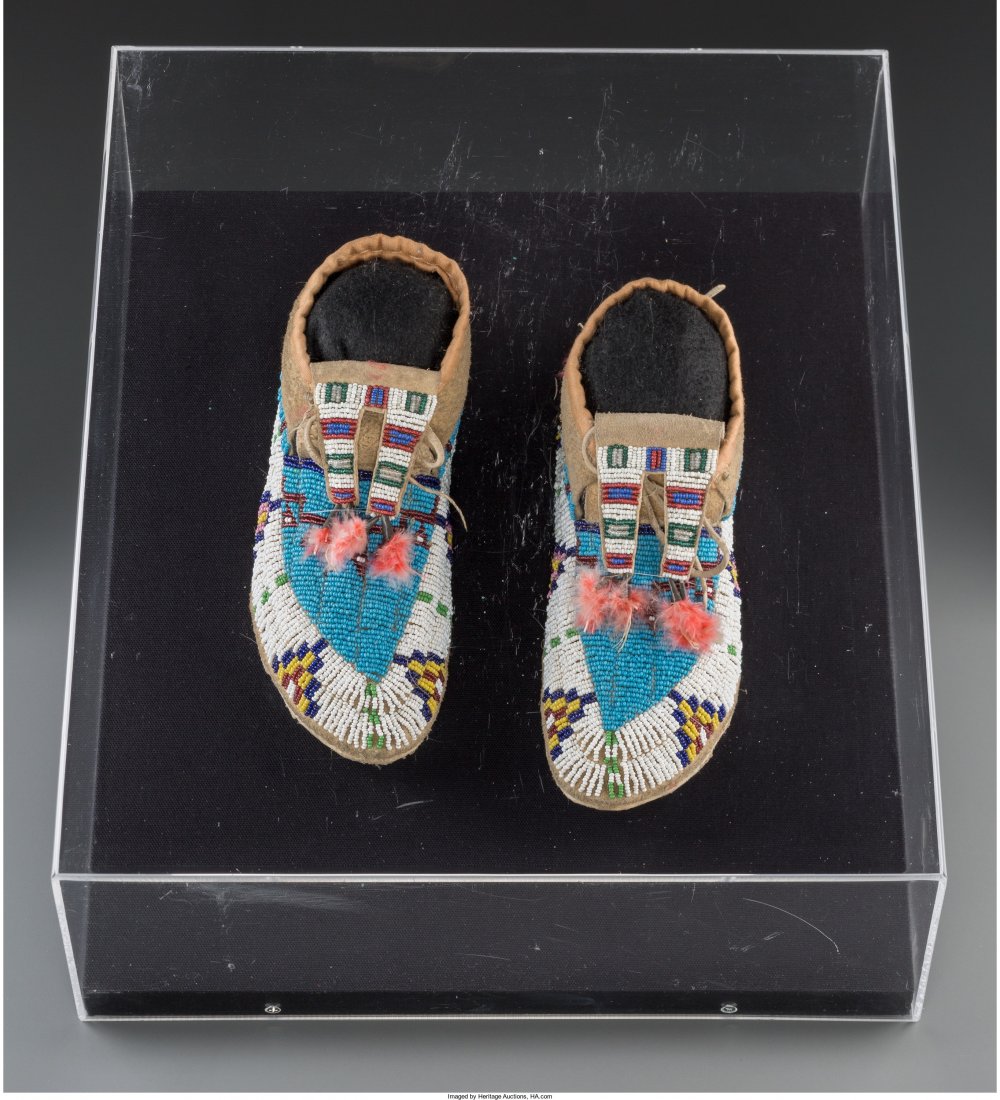 A Pair of Sioux Beaded Hide Moccasins c. 1910 : A Pair of Sioux Beaded Hide Moccasins c. 1910 hide, glass seed beads, metal cones,