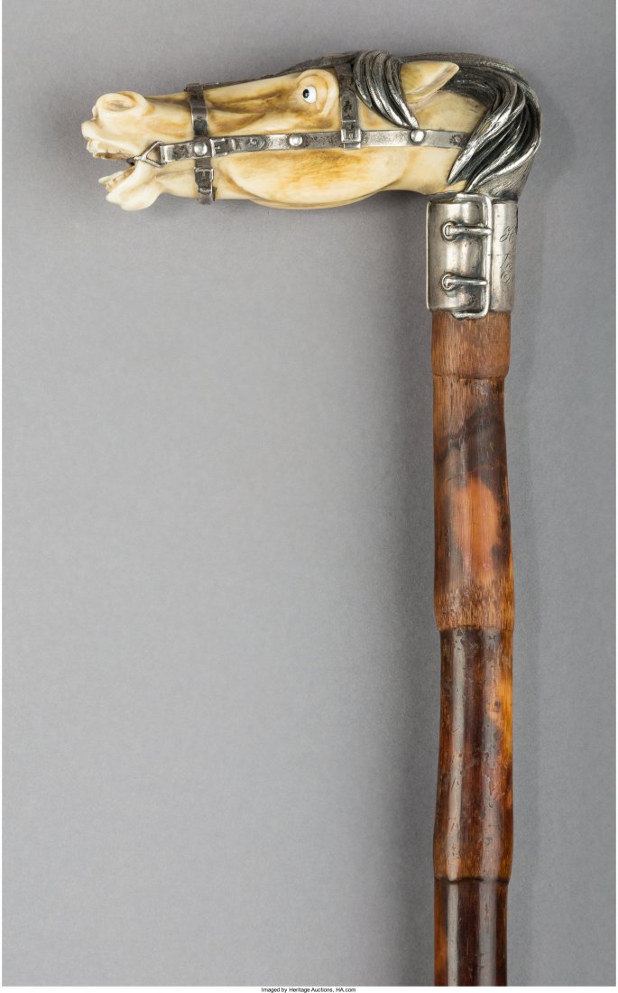 A Bone and Silver-Mounted Figural Horse Cane, early: A Bone and Silver-Mounted Figural Horse Cane, early 20th century Marks: 925, STERLING 34 inches high x 4-3/8 inches wide (86.4 x 11.1 cm) Property from the Estate of Charles Schalebaum Cane having woo