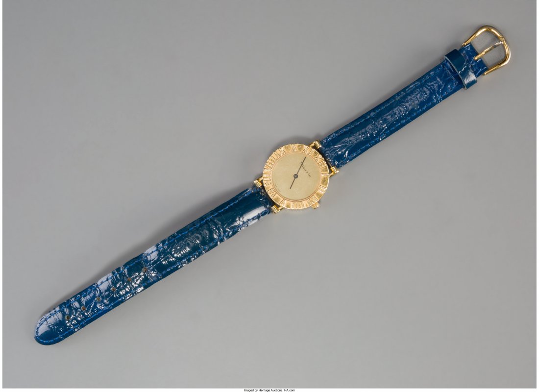 An 18K Gold Tiffany & Co. Lady's Wrist Watch, New York: An 18K Gold Tiffany & Co. Lady's Wrist Watch, New York Marks: TIFFANY & CO, 18K, (various) 8 inches long (20.3 cm) (laid flat) Property from the Estate of Charles Schalebaum HID04901242017