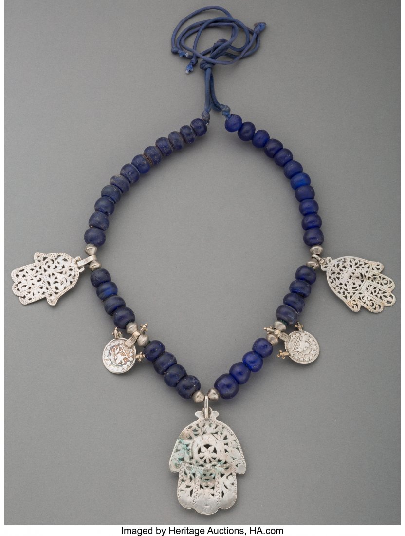 A Tunisian Silver and Glass Bead Necklace Two l: A Tunisian Silver and Glass Bead Necklace Two lotus ornaments with bust hallmark indi