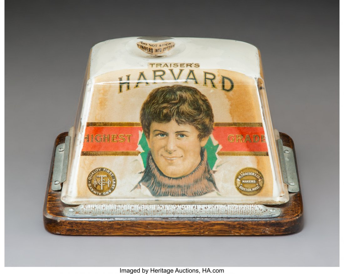A Brunhoff Mfg. Co. Glass, Oak, and Metal Commer: A Brunhoff Mfg. Co. Glass, Oak, and Metal Commercial Countertop Cigar Cutter with Traiser's Harvard Advertisements, Cincinnati, Ohio, early 20th century Marks: PATENTS 621185, 666074, THE BRUNHOFF MFG