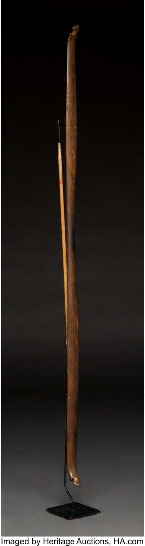 A Northern California Carved Wood Bow and Arrow: A Northern California Carved Wood Bow and Arrow c. 1880 wood, copper, sinew, paint, metal stand Provenance: William & Sheryl Sloup Collection Length of bow: 44 inches HID03101242017