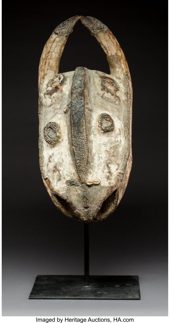 A Large Toussian Mask Burkina Faso Wood mask w: A Large Toussian Mask Burkina Faso Wood mask with kaolin and cowrie shells. Provenance: Dr. & Mrs. John Finley Height: 24 ½ inches HID03101242017