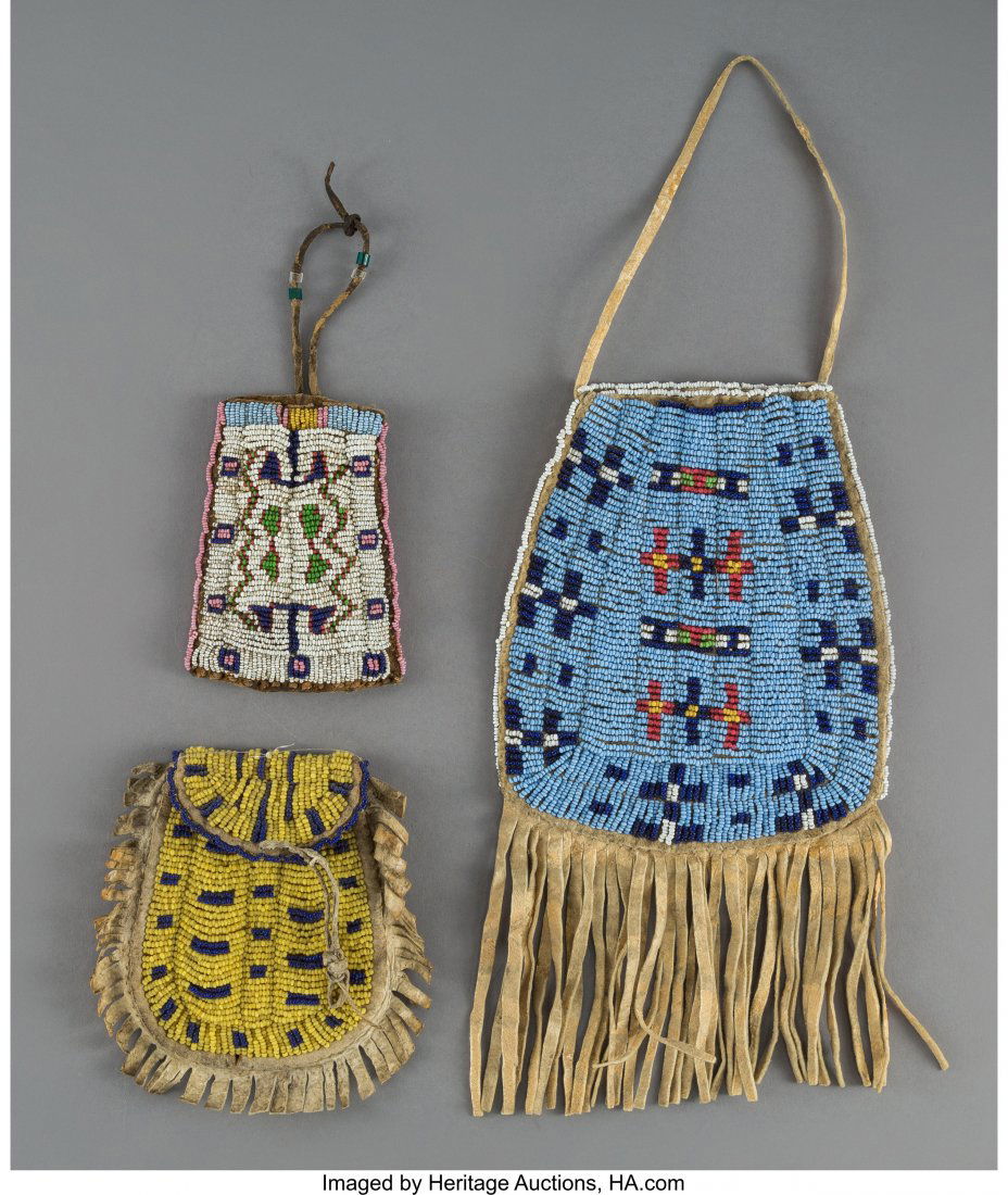 Three Sioux Beaded Hide Pouches c. 1890 hide,: Three Sioux Beaded Hide Pouches c. 1890 hide, buffalo hide, glass seed beads, tubular glass beads, sinew Lengths: 4 ¼ and 6 ¼ inches, excluding fringe HID03101242017