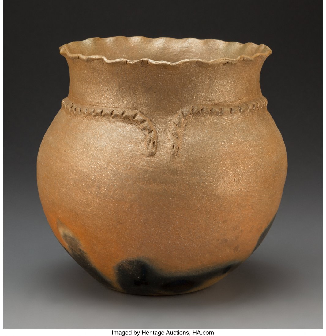 A Picuris Micaceous Clay Jar: A Picuris Micaceous Clay Jar Diameter: 9 inches HID03101242017