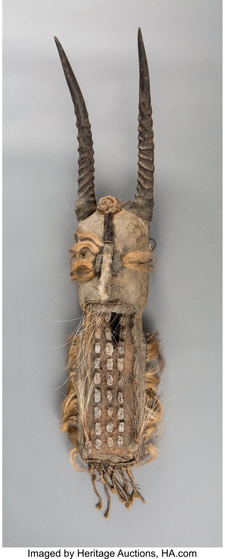 A Bamana Komo Secret Society Mask Wood, iron,: A Bamana Komo Secret Society Mask Wood, iron, horn, porcupine quills, kaolin and organic materials. Thickly accumulated over time and use. Provenance: Dr. & Mrs. John Finley Purchased December 1987 fr