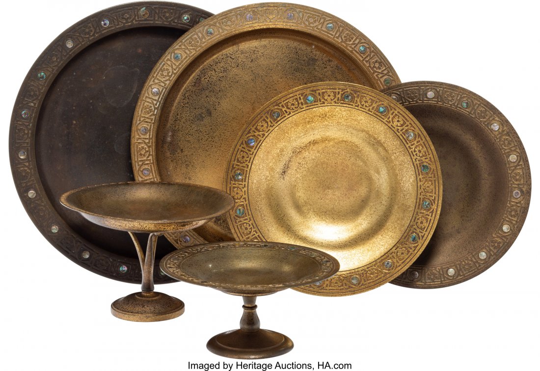 A Group of Six Tiffany Studios Gilt Bronze Plate: A Group of Six Tiffany Studios Gilt Bronze Plates and Compotes, circa 1920 Marks: TIFFANY STUDIOS, NEW YORK, (various) 1 x 12-1/8 x 12-1/8 inches (2.5 x 30.8 x 30.8 cm) (largest, charger) The group co