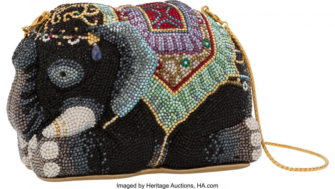 Judith Leiber Crystal Elephant Minaudiere Condit: Judith Leiber Crystal Elephant Minaudiere Condition: 2 6" Width x 4" Height x 2.5" Depth This minaudiere is done in multicolor crystals with gold hardware, featuring a chain strap that can be tucked i