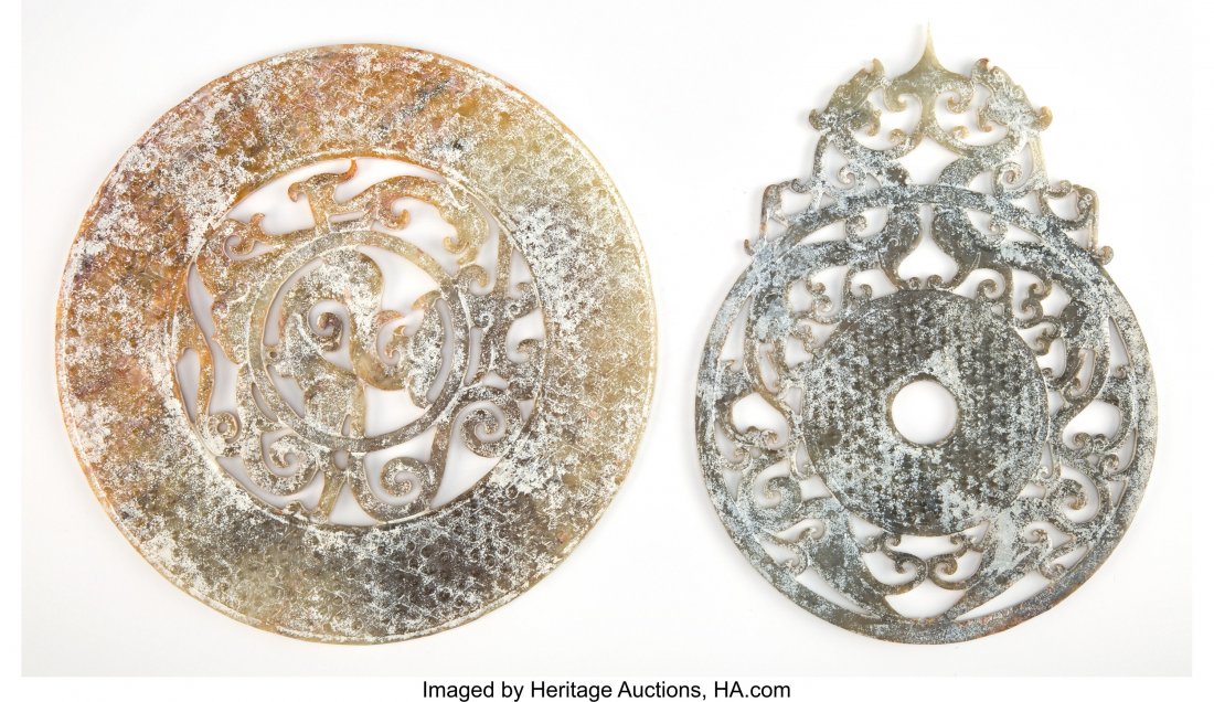 Two Chinese Carved Jade Dragon Bi Discs 8-3/4 in: Two Chinese Carved Jade Dragon Bi Discs 8-3/4 inches (22.2 cm) (largest) The lot comprising: 1 celadon jade bi disc; 1 yellow and jade bi disc. 2 Total HID03101242017
