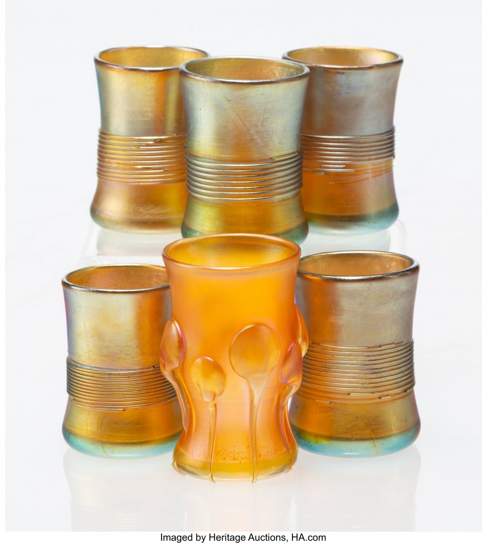 Six Tiffany Studios Favrile Glass Cups, early 20: Six Tiffany Studios Favrile Glass Cups, early 20th century Marks: L.C.T., (various) 2 x 1-1/4 inches diameter (5.1 x 3.2 cm) (tallest) A COLLECTION OF STEUBEN AND TIFFANY GLASS FROM A MIDWESTERN ESTAT