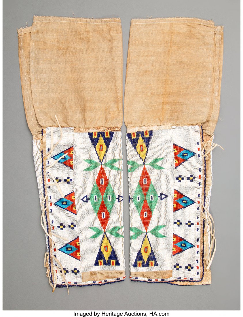 A Pair of Sioux Women's Beaded Hide Leggings c.: A Pair of Sioux Women's Beaded Hide Leggings c. 1900 hide, glass seed beads, sinew, cotton cloth, thread Heights: 19 &frac12; inches each HID03101242017