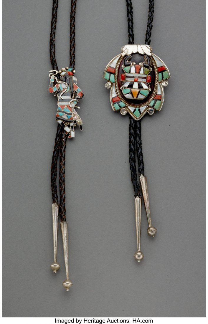 Two Zuni Bolo Ties c. 1955 and 1990 silver, tu: Two Zuni Bolo Ties c. 1955 and 1990 silver, turquoise, jet, coral, mother of pearl, abalone, shell, commercial leather Lengths of slides: 2 &frac12; and 2 &frac34; inches HID03101242017
