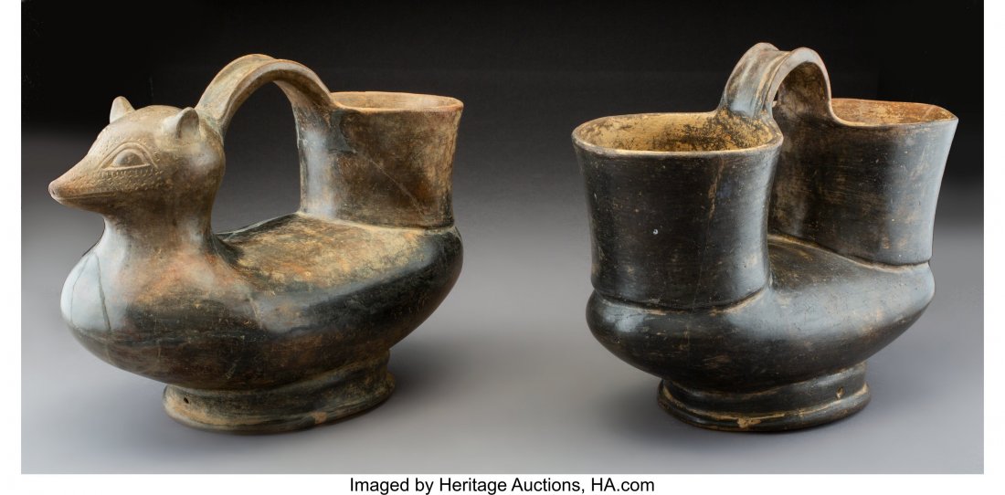 Two Tairona Bridge-handled Vessels Colombia, c.: Two Tairona Bridge-handled Vessels Colombia, c. 800 – 1200 AD Both crafted from dark brown to black burnished earthenware, each standing on an oval foot with long central chamber, large cup-shap