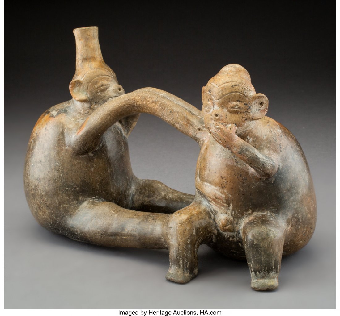 A Vicus Whistling Vessel with Monkeys North Coa: A Vicus Whistling Vessel with Monkeys North Coast of Peru, c. 300 BC – 300 AD An unusual double-chambered vessel in brown burnished earthenware, one monkey seated with proper left hand held to m