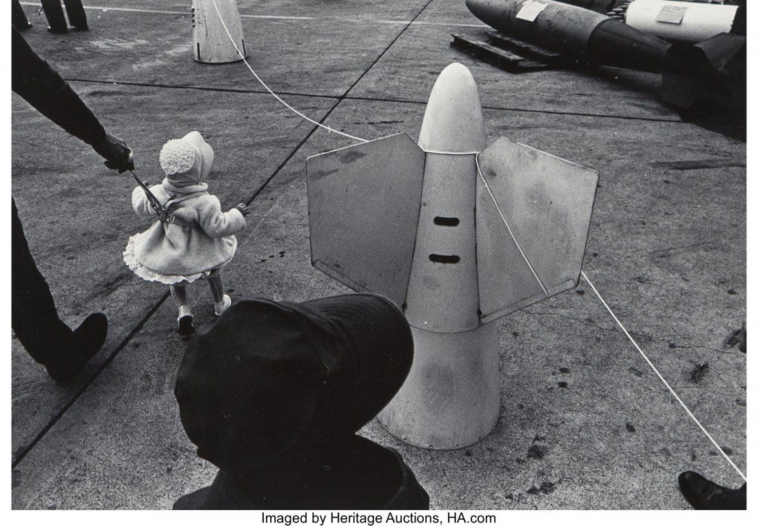 Ken Graves (American, 1945-2016) Toddler Among B: Ken Graves (American, 1945-2016) Toddler Among Ballistic Missiles at Naval Base Gelatin silver 5-3/8 x 7-7/8 inches (13.7 x 20.0 cm) Signed and titled in ink verso. HID03101062020 © 2020 Heritage