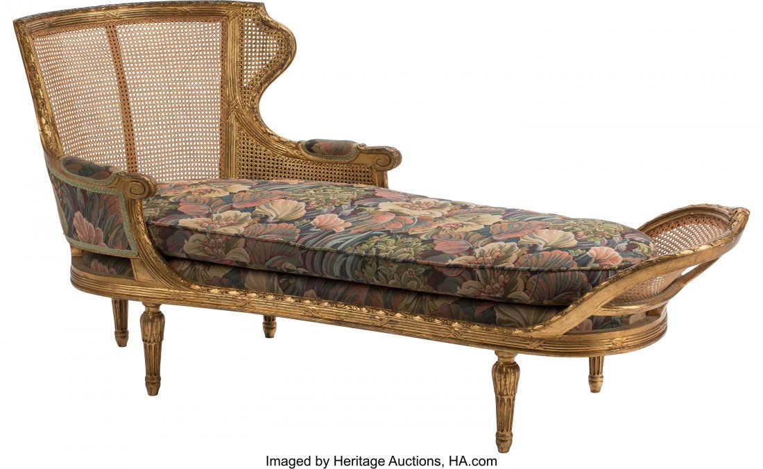 A French Louis XV-Style Caned Carved Giltwood Ch: A French Louis XV-Style Caned Carved Giltwood Chaise Lounge, 19th century 32-1/2 x 68 x 25 inches (82.6 x 172.7 x 63.5 cm) The chaise lounge with curved caned headboard leading to scroll arms, with si