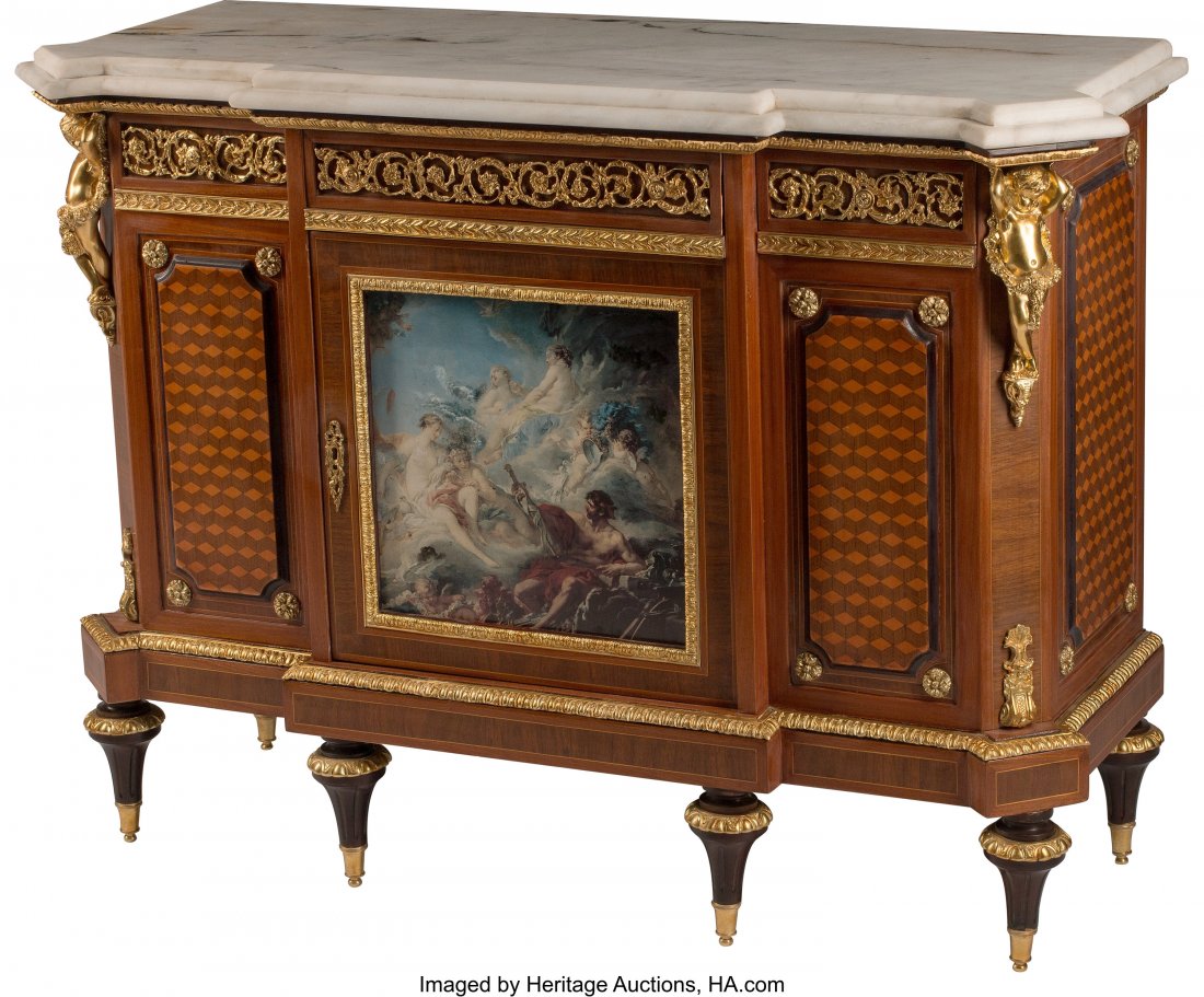 A Louis XVI-Style Gilt Bronze and Porcelain Moun: A Louis XVI-Style Gilt Bronze and Porcelain Mounted Mahogany Parquetry Commode 40 x 55-1/2 x 20 inches (101.6 x 141.0 x 50.8 cm) The commode with canted rectangular marble top, supported by two gilt b