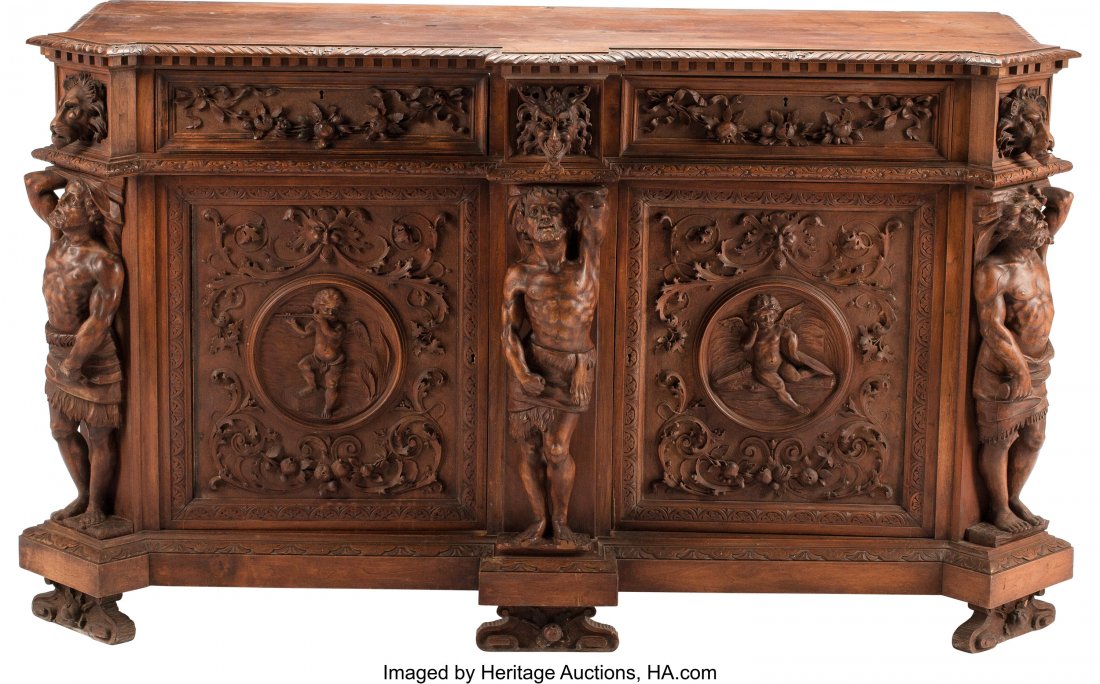 An Italian Renaissance-Style Carved Hardwood Cre: An Italian Renaissance-Style Carved Hardwood Credenza, 19th century 43 x 74 x 28 inches (109.2 x 188.0 x 71.1 cm) The credenza with carved masks, cherubs, scrolling foliate, and floral swags to case, 