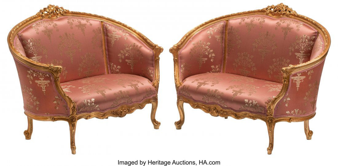 A Pair of Louis XV-Style Carved Gilt Wood and Up: A Pair of Louis XV-Style Carved Gilt Wood and Upholstered Settees 38 x 51 x 28 inches (96.5 x 129.5 x 71.1 cm) (each) The pair of setees with floral and foliate crest, leading to acanthus capped arms,