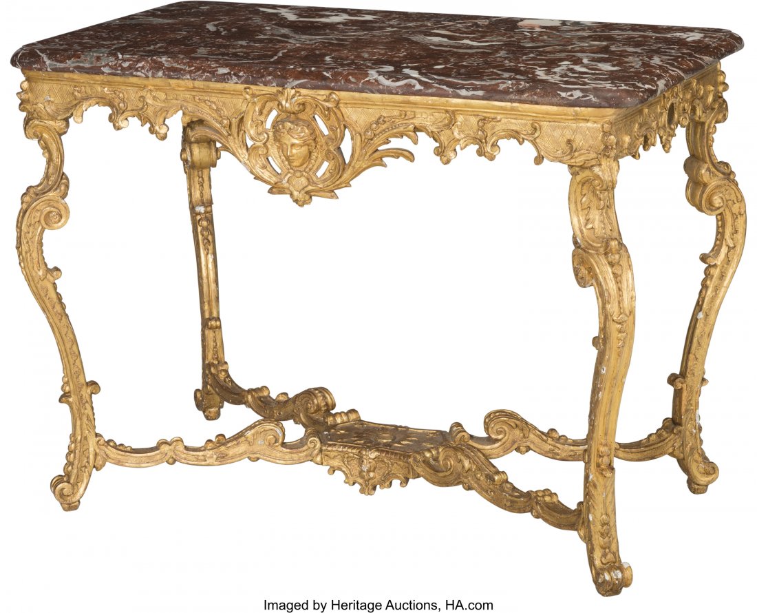 A French Régence Carved Giltwood Salon Ta: A French Régence Carved Giltwood Salon Table with Rouge Marble Top, circa 1725 with later elements 32 h x 43 w x 23-1/2 d inches (81.3 x 109.2 x 59.7 cm) PROPERTY OF A LADY OF TITLE PROVENANCE: