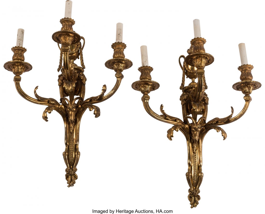 A Pair of Louis XV-Style Gilt Bronze Wall Sconce: A Pair of Louis XV-Style Gilt Bronze Wall Sconces with Ram's Head Motif, 19th century 23 x 17 x 9-1/2 inches (58.4 x 43.2 x 24.1 cm) (each) The pair of wall sconces, each topped with urn-forms draped 