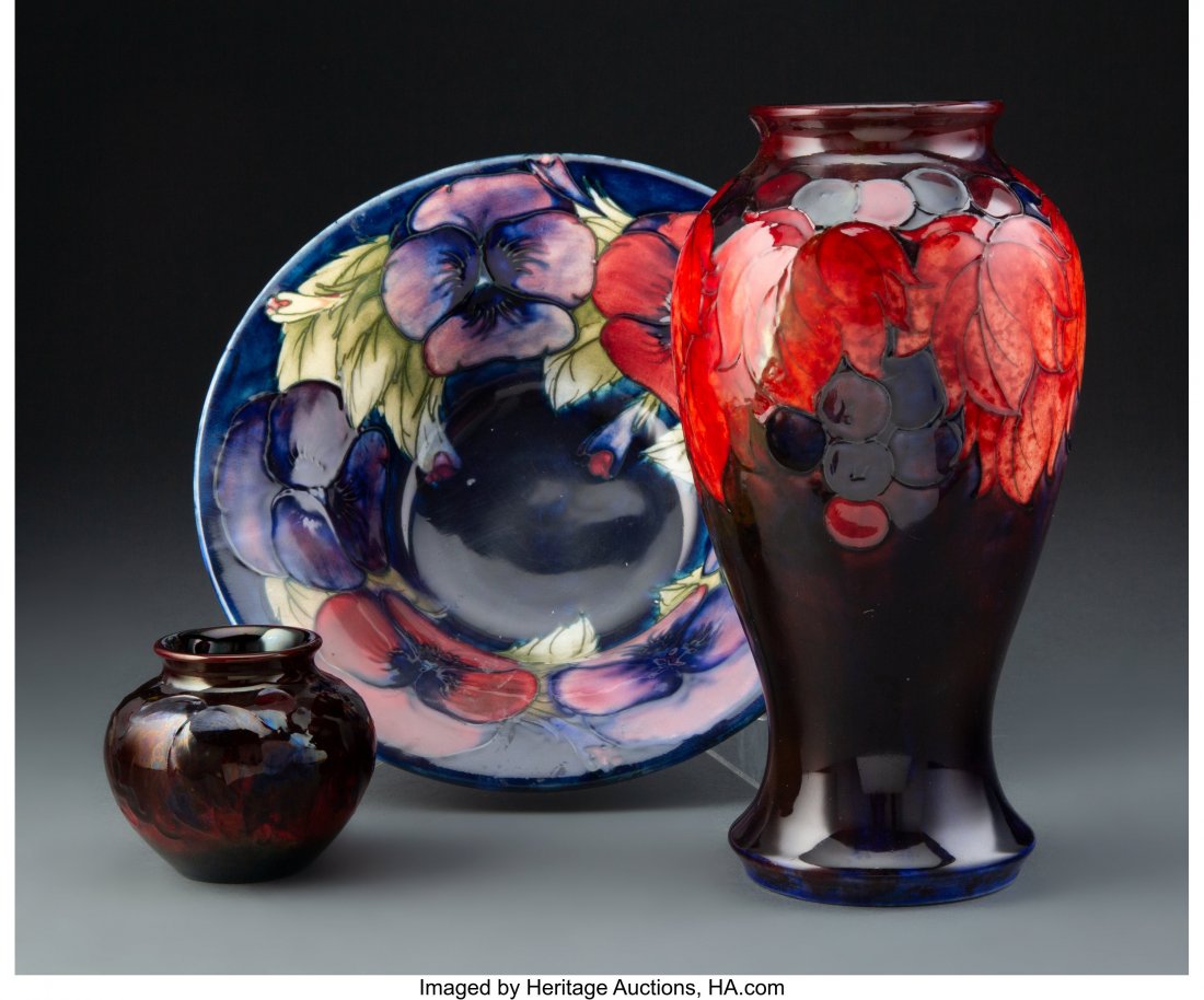 Group of Three William Moorcroft Pottery Table A: Group of Three William Moorcroft Pottery Table Articles, circa 1930 Marks to tallest: MADE IN ENGLAND, MOORCROFT 9 inches (22.9 cm) (tallest) The group comprising: 1 Pansy patterned bowl; 1 Berry patt
