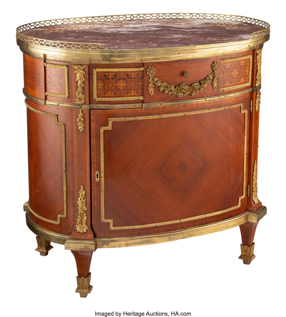 A French Louis XVI-Style Ormolu Mounted Kingwood: A French Louis XVI-Style Ormolu Mounted Kingwood Oval Commode, 20th century 33-1/4 x 34-1/2 x 23-3/4 inches (84.5 x 87.6 x 60.3 cm) HID03101062020 © 2020 Heritage Auctions | All Rights Reserved
