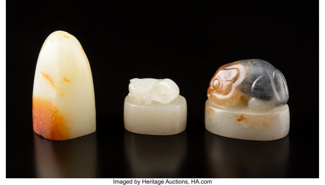 A Group of Three Chinese Jade Seals 1-5/8 x 0-7/: A Group of Three Chinese Jade Seals 1-5/8 x 0-7/8 x 1 inches (4.1 x 2.2 x 2.5 cm) (tallest, pendant) The lot comprising one pendant seal, one seal with foo dog finial, one seal with mythical creature