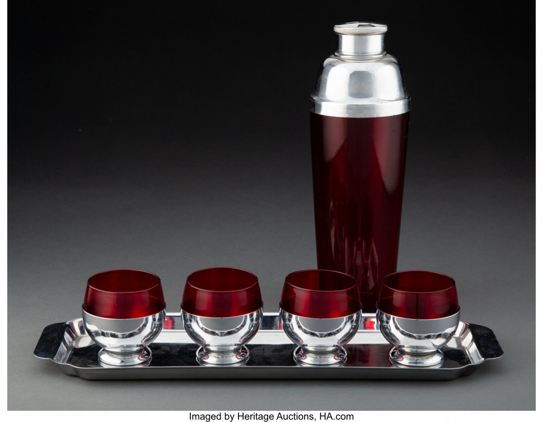 A Six-Piece Chase Chrome and Red Glass Barware S: A Six-Piece Chase Chrome and Red Glass Barware Set, circa 1930 Marks: CHASE U.S.A., (centaur) 11-1/8 x 4 x 4 inches (28.3 x 10.2 x 10.2 cm) (tallest, shaker) The set comprising: 1 cocktail shaker; 4 r