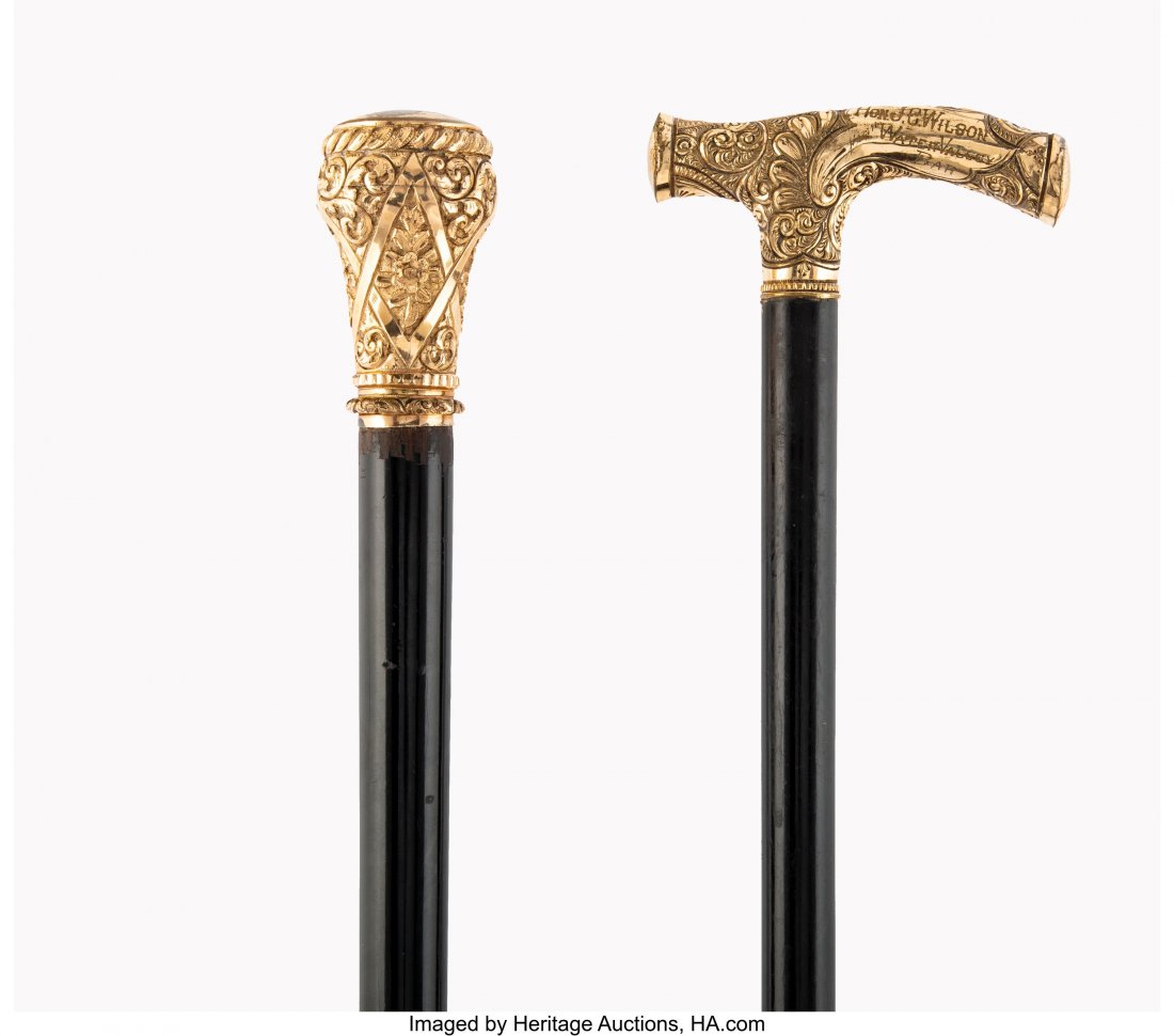 Two American Ebonized Wood Walking Sticks with G: Two American Ebonized Wood Walking Sticks with Gilt Metal Handles, 19th century 37 inches (94.0 cm) (longest) One walking stick inscribed HON. J.C. WILSON, WATER VALLEY BAR to pommel, and the other wi