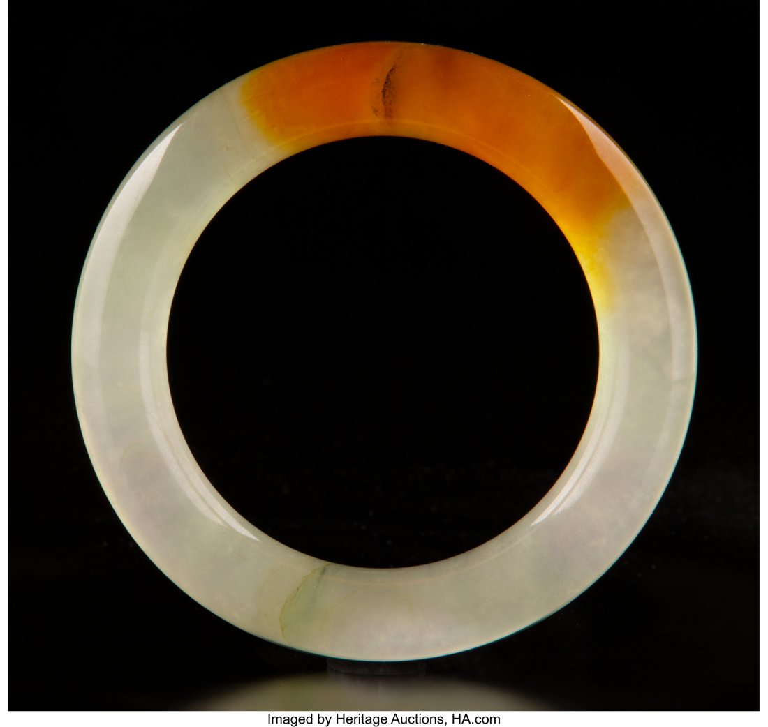 A Chinese Jadeite Bangle with Russet Splash, 20t: A Chinese Jadeite Bangle with Russet Splash, 20th century 3-1/4 x 0-1/2 inches (8.3 x 1.3 cm) HID03101062020 © 2020 Heritage Auctions | All Rights Reserved