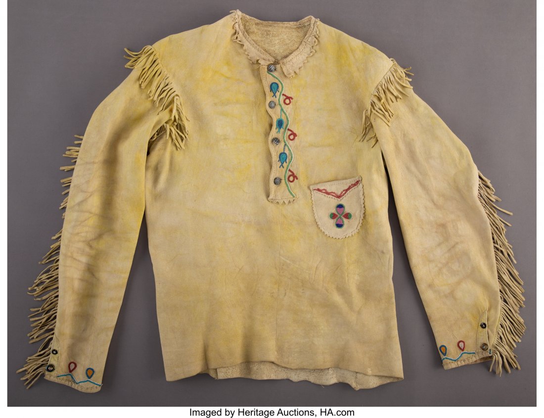 A Northern Plains Beaded Hide Shirt c. 1830 hi: A Northern Plains Beaded Hide Shirt c. 1830 hide, yellow ochre pigment, glass seed beads, thread Provenance: From the L. D. Bax Collection Length: 27 inches HID03101062020 © 2020 Heritage Auction
