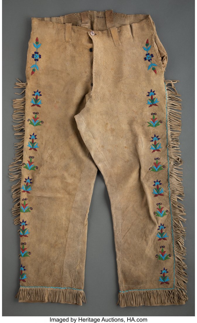 A Pair of Northern Plains Man's Beaded Hide Trou: A Pair of Northern Plains Man's Beaded Hide Trousers c. 1890 hide, small brass and glass beads, sinew, muslin, shell button Provenance: From the L. D. Bax Collection Length: 44 inches HID03101062020 &