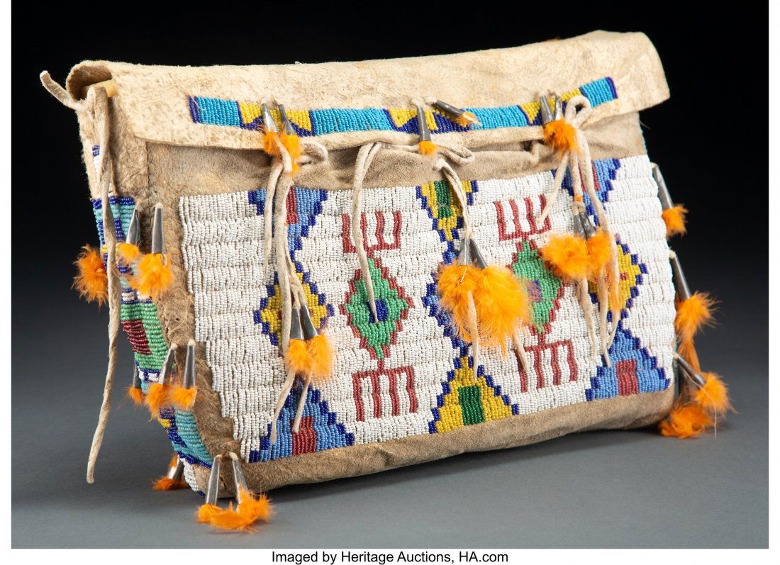 A Sioux Beaded Hide Possible Bag c. 1910 hide: A Sioux Beaded Hide Possible Bag c. 1910 hide, glass seed beads, metal cones, dyed chicken feathers, sinew Provenance: C. O. Walker Collection, Cowboy Hall of Fame, Oklahoma City, OK Width: 14 inches