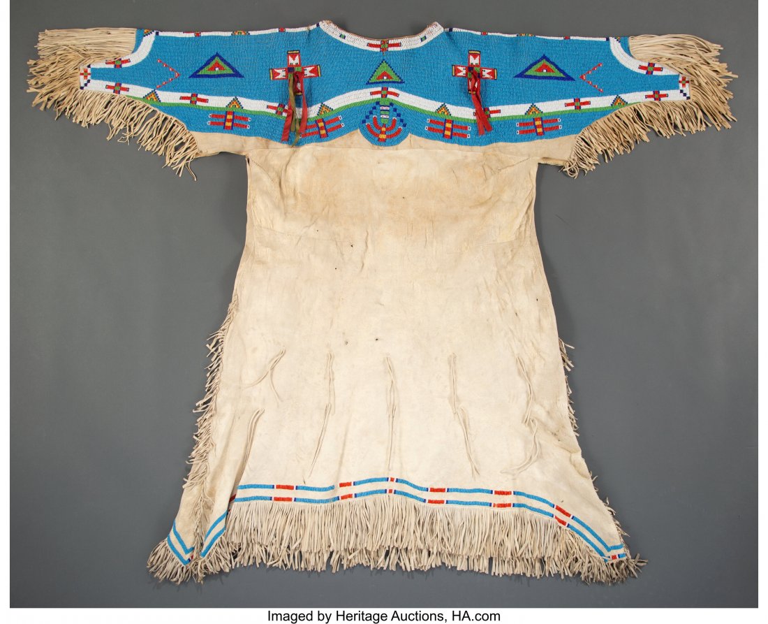 A Sioux Beaded Hide Dress c. 1910 hide, glas: A Sioux Beaded Hide Dress c. 1910 hide, glass seed beads, silk ribbon, sinew Provenance: Collected in 1994 from Mandan Indian Shriner's, El Zagel Temple, Fargo, ND, who assembled material predominantl