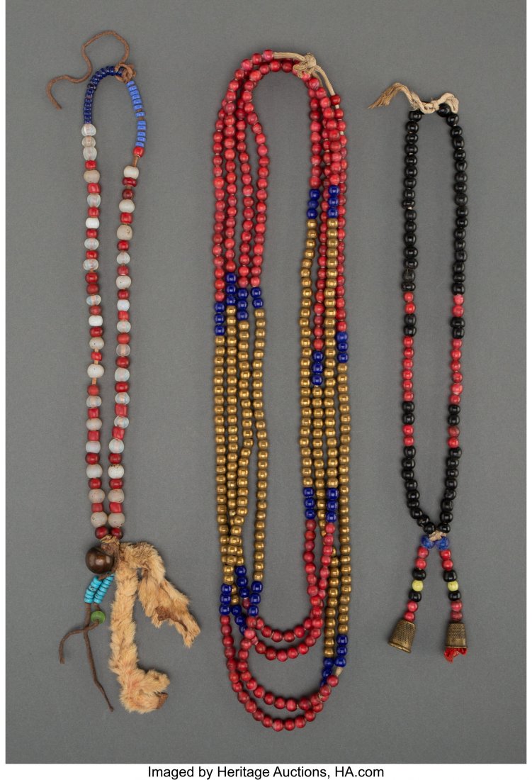 Three Plains / Plateau Necklaces c. 1890 - 1910: Three Plains / Plateau Necklaces c. 1890 - 1910 brass and glass beads, hide fur, brass thimbles, muslin, cotton string Provenance: From the L. D. Bax Collection Lengths: ranging from 13 &frac34; t