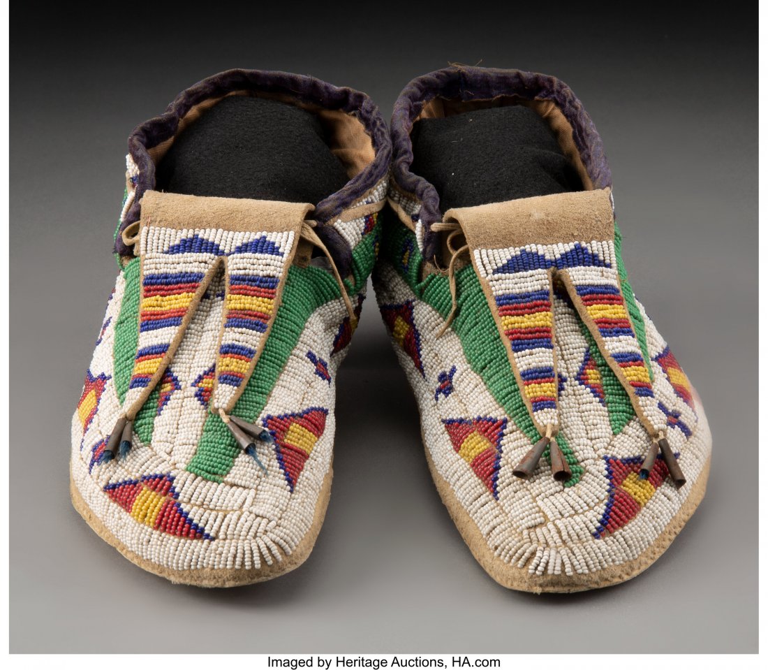 A Pair of Sioux Beaded Hide Moccasins c. 1890 : A Pair of Sioux Beaded Hide Moccasins c. 1890 hide, glass seed beads, velvet, sinew, thread Lengths: 10 &frac12; inches HID03101062020 © 2020 Heritage Auctions | All Rights Reserved