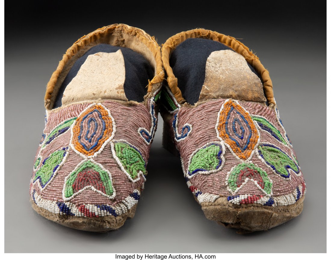 A Pair of Sioux Beaded Hide Moccasins c. 1900 : A Pair of Sioux Beaded Hide Moccasins c. 1900 hide, glass seed beads, sinew Lengths: 10 inches each HID03101062020 © 2020 Heritage Auctions | All Rights Reserved