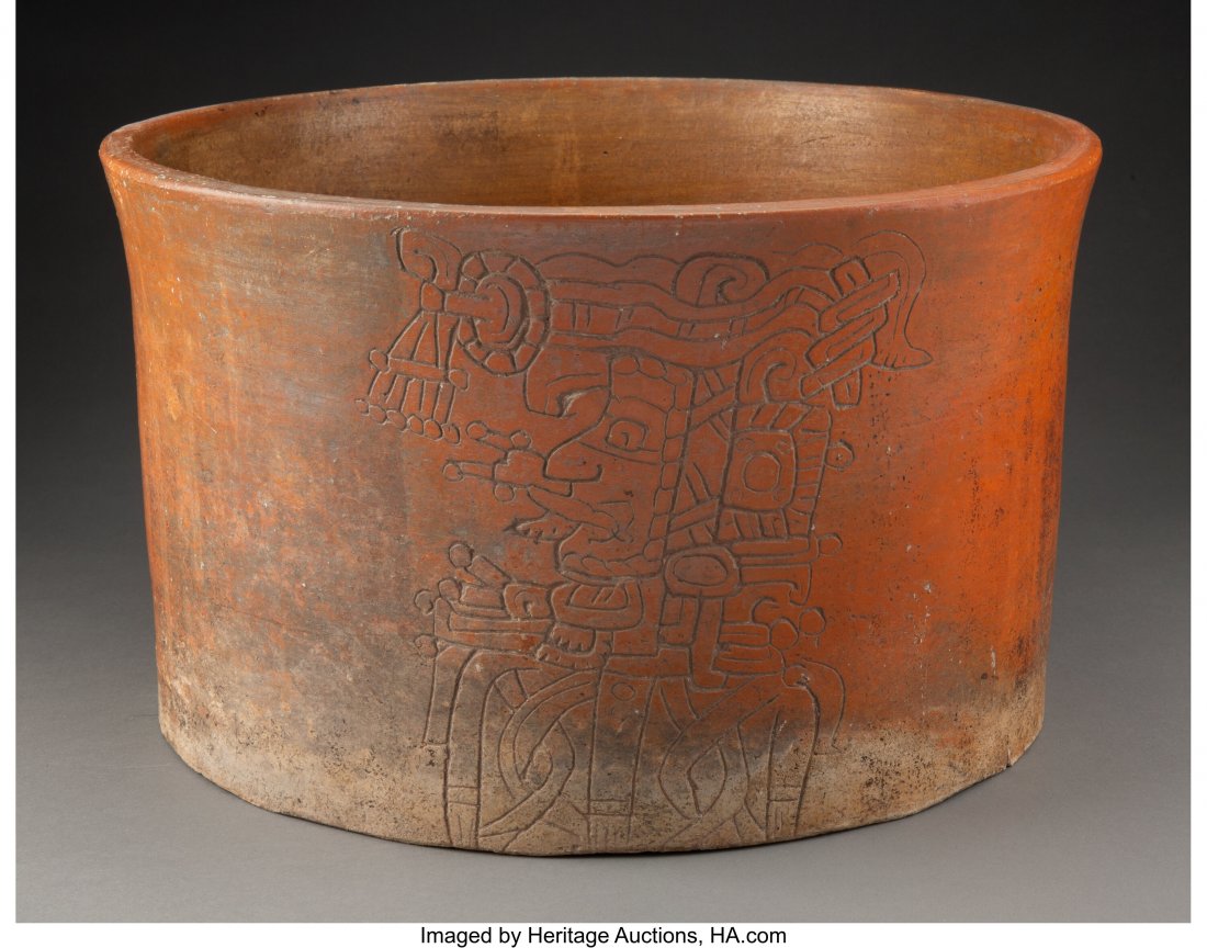 A Large Maya Cache Vessel Guatemala, Late Class: A Large Maya Cache Vessel Guatemala, Late Classic, circa 600 – 900 AD Large earthenware cylinder with sides gently flaring to rim, burnished brown-orange slip. One side incised to depict a lord 