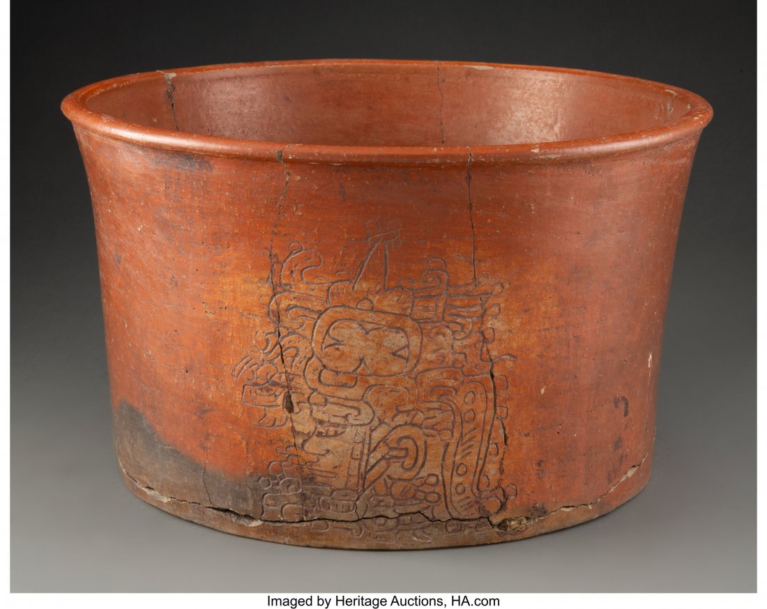 A Large Maya Cache Vessel Guatemala, Late Class: A Large Maya Cache Vessel Guatemala, Late Classic, circa 600 – 900 AD Large earthenware cylinder with sides gently flaring to rim, burnished brown slip. One side incised to depict a lord or rule