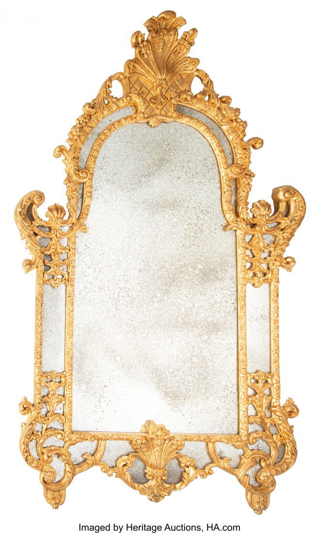 A Continental Carved Gilt Wood Mirror Frame with: A Continental Carved Gilt Wood Mirror Frame with an Antique Mirror, late 19th-early 20th century 65 x 40 x 2-1/2 inches (165.1 x 101.6 x 6.4 cm) Property from the Collection of R. Douglas Houser, Dall
