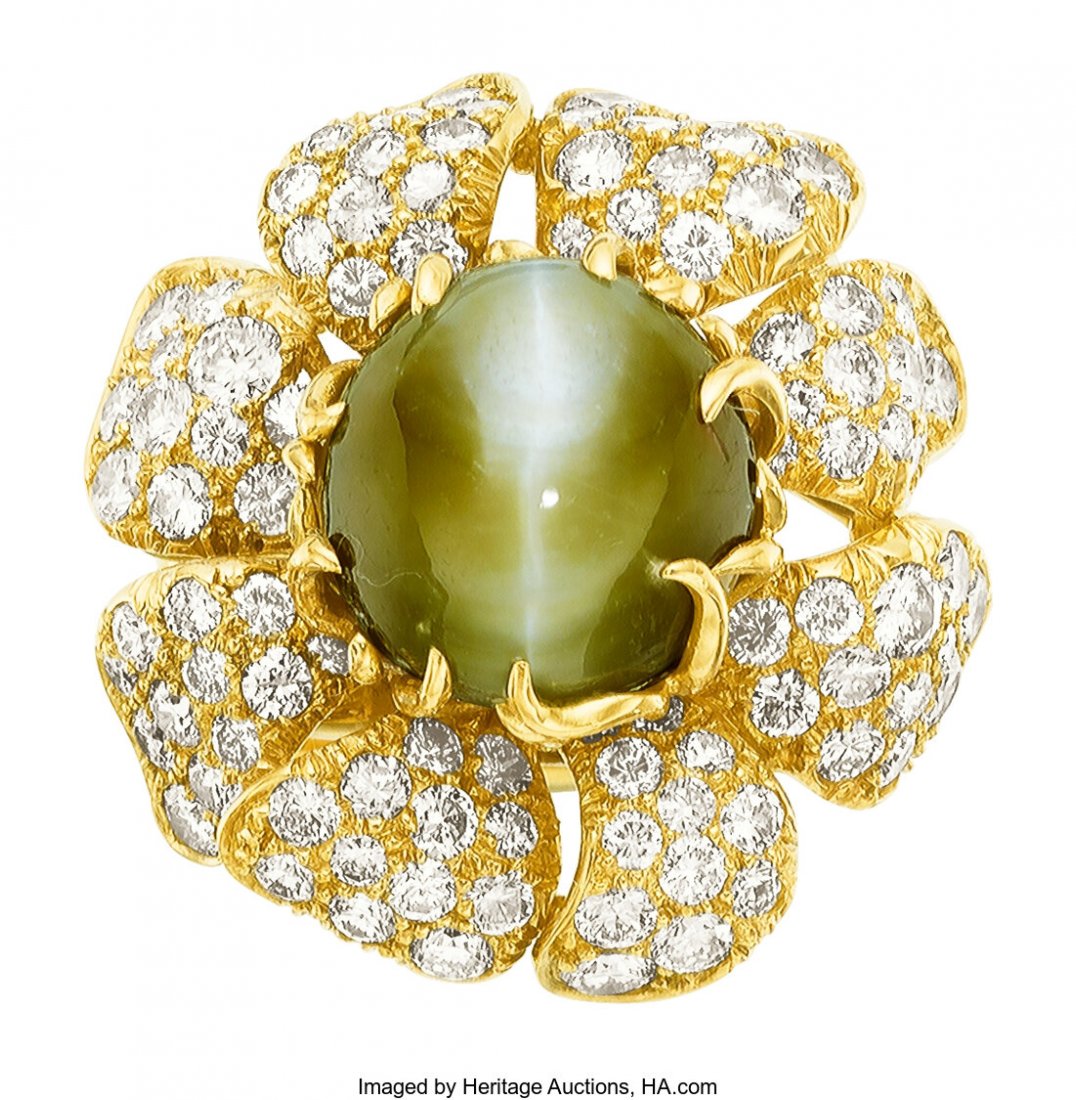 Cat's-Eye Chrysoberyl, Diamond, Gold Ring, Juliu: Cat's-Eye Chrysoberyl, Diamond, Gold Ring, Julius Cohen The flower ring features a round-shaped cat's-eye chrysoberyl cabochon measuring 13.00 x 11.00 x 9.00 mm and weighing approximately 12.30 carats