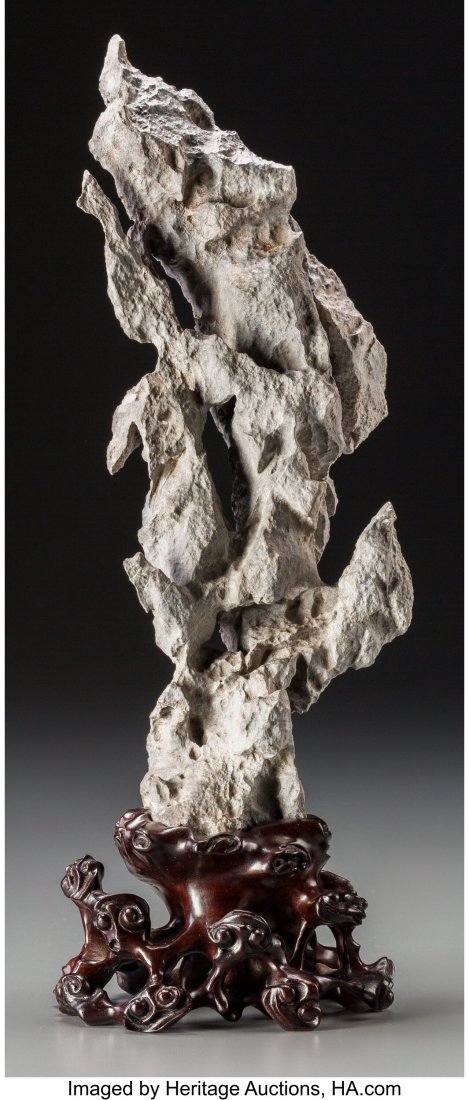 A Chinese Scholar's Rock on Carved Hardwood Stan: A Chinese Scholar's Rock on Carved Hardwood Stand 14-1/2 inches (36.8 cm) (including stand) HID03101062020 © 2020 Heritage Auctions | All Rights Reserved