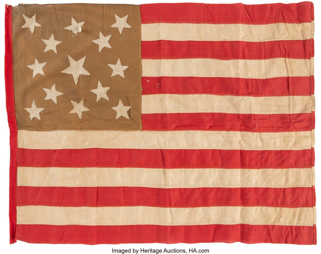 United States 13-Star Flag. 32" x 25" cotton fla: United States 13-Star Flag. 32" x 25" cotton flag with thirteen stars in the canton. The stripes and hoist are machine-stitched. The stars, which appear on both sides of the canton, are appliqued. The