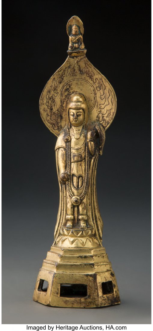 An Asian Gilt Bronze Standing Buddha 6-7/8 x 2 x: An Asian Gilt Bronze Standing Buddha 6-7/8 x 2 x 1-3/4 inches (17.5 x 5.1 x 4.4 cm) HID03101062020 © 2020 Heritage Auctions | All Rights Reserved