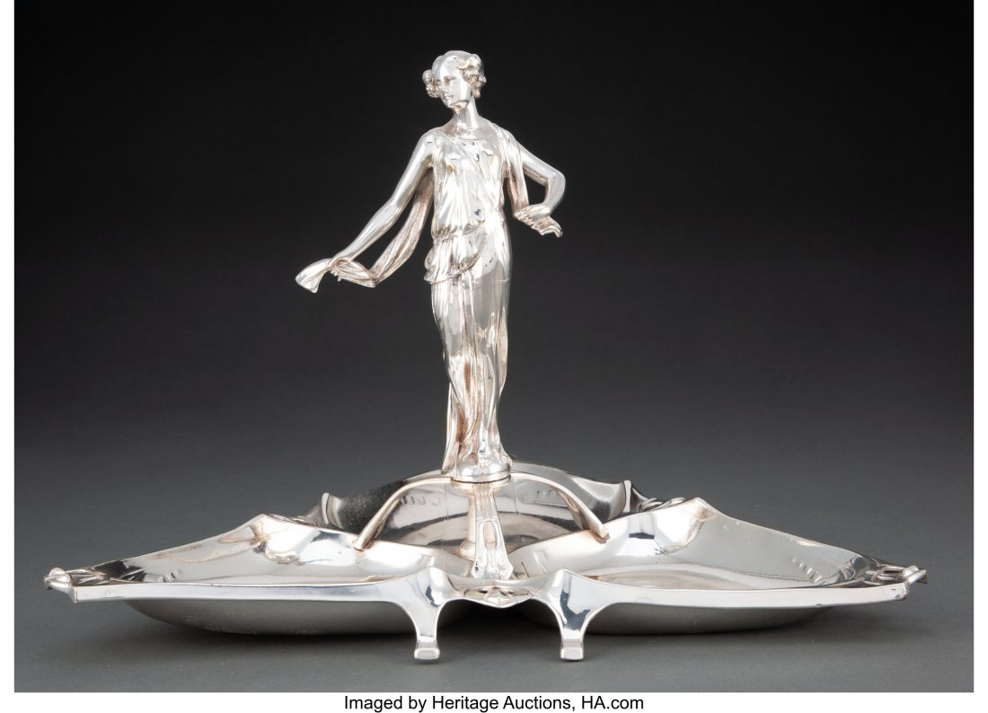 WMF Jugendstil Silver-Plated Figural Centerpiece: WMF Jugendstil Silver-Plated Figural Centerpiece, circa 1905 Marks: B, (ostrich-WMF-G), I/0, OX 10 x 14-1/4 inches (25.4 x 36.2 cm) The Valerio Collection HID03101062020 © 2020 Heritage Auctions 